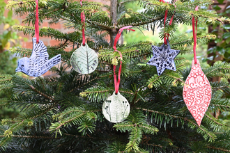 Festive clay baubles hanging from a tree