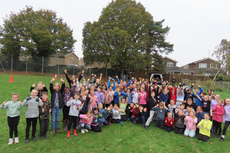 Group pic of kids arms in air