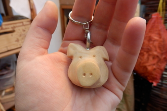 A wooden keying carved in the shape of a pigs head