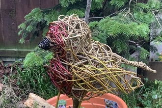 a robin sculpture made of woven willow 