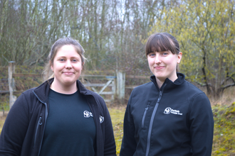 Becky and Linsey standing outside looking at the camera smiling