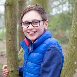 Henry, Youth Board member, standing by a tree, image credit Simply C Photography